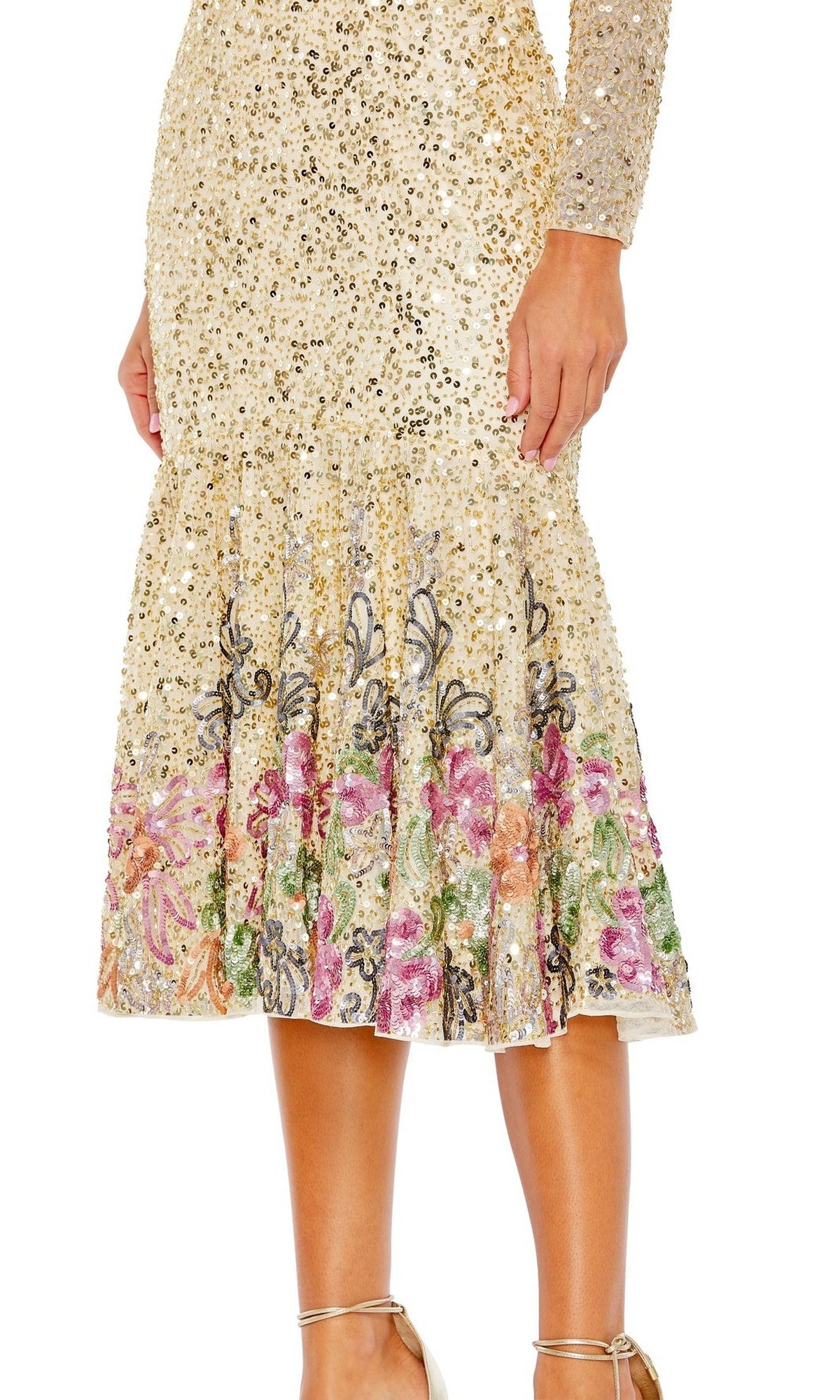 A person wearing the Beaded Midi Wedding Guest Dress: Mac Duggal 5589, a gold sequin tea-length dress with long sleeves, a flared skirt, and multicolored floral embroidery near the hem.